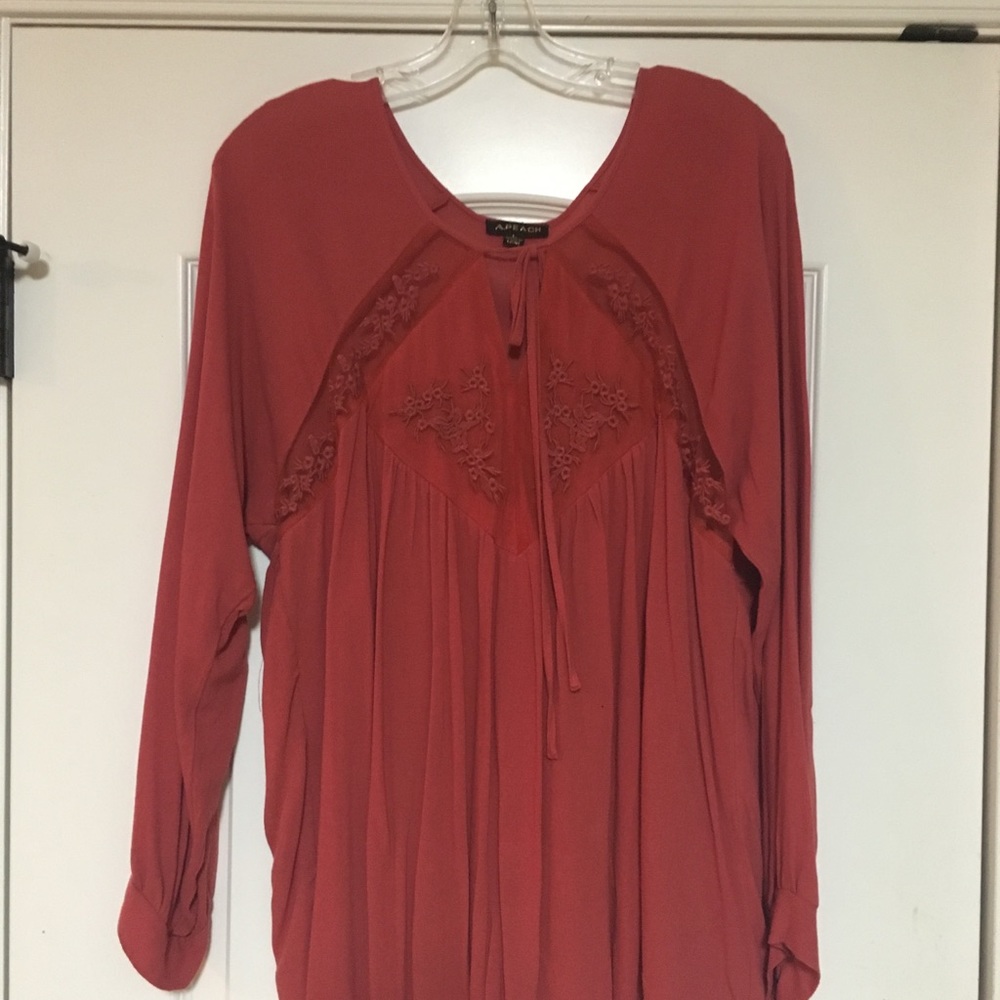 Red long sleeve top with lace cutouts